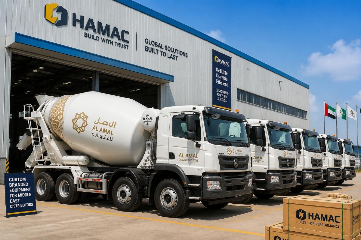 Custom branded concrete mixer trucks ready for loading at a factory warehouse
