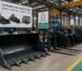 Custom agricultural loader attachment set at a manufacturer production facility